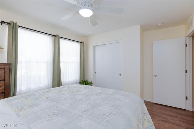 bedroom featuring hardwood / wood-style flooring, a closet, and ceiling fan