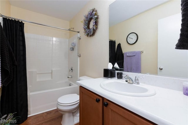 full bathroom featuring vanity, hardwood / wood-style flooring, shower / bath combination with curtain, and toilet