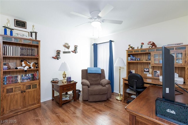 home office with wood-type flooring and ceiling fan