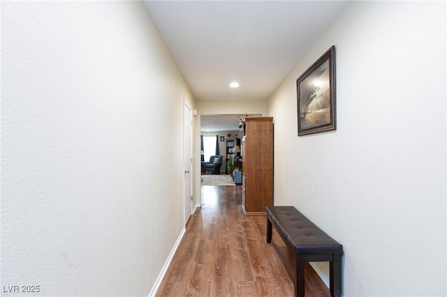 corridor with hardwood / wood-style floors