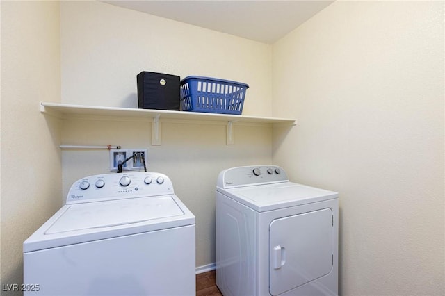 clothes washing area with hardwood / wood-style flooring and washing machine and dryer