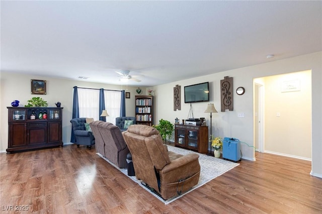 living room featuring ceiling fan and wood-type flooring