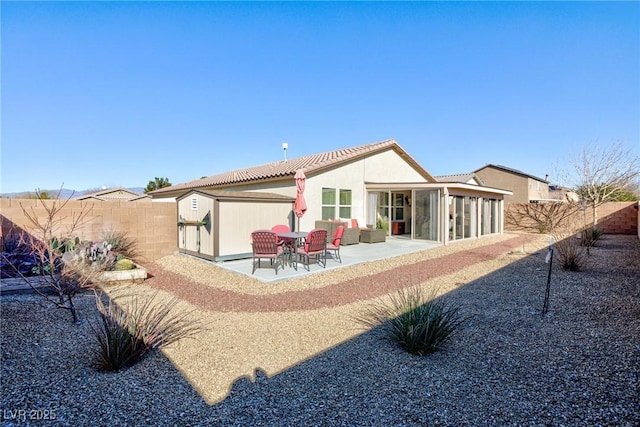 back of property featuring a sunroom and a patio