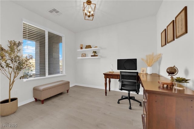 office area with an inviting chandelier and light hardwood / wood-style floors