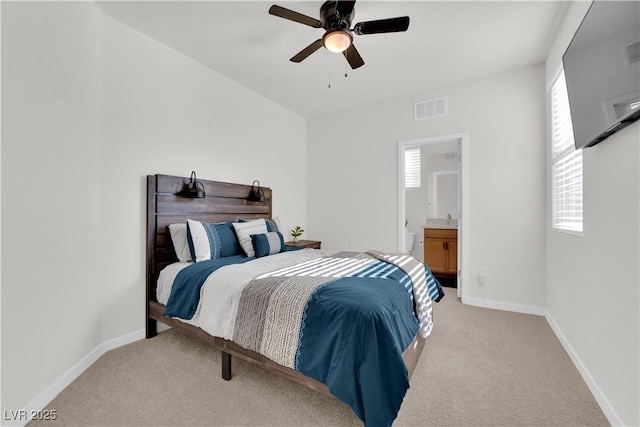 carpeted bedroom featuring sink, ensuite bath, and ceiling fan