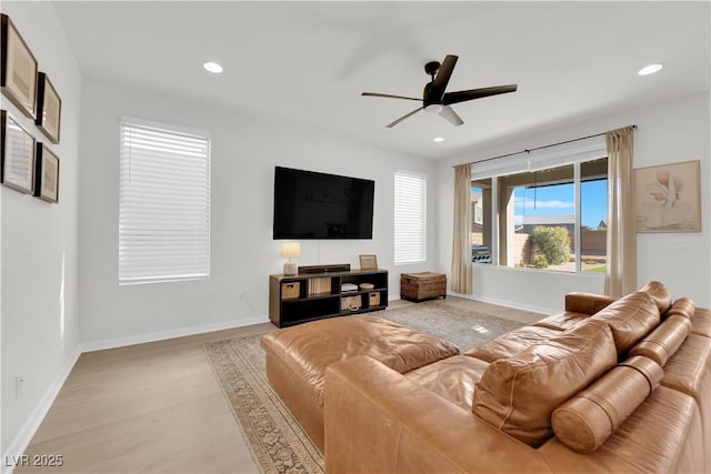 living room with ceiling fan and light hardwood / wood-style floors