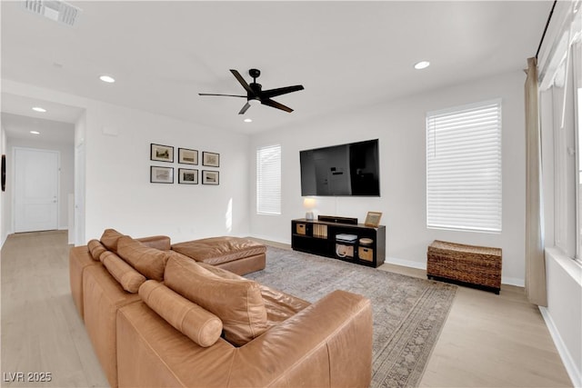 living room featuring ceiling fan and light wood-type flooring