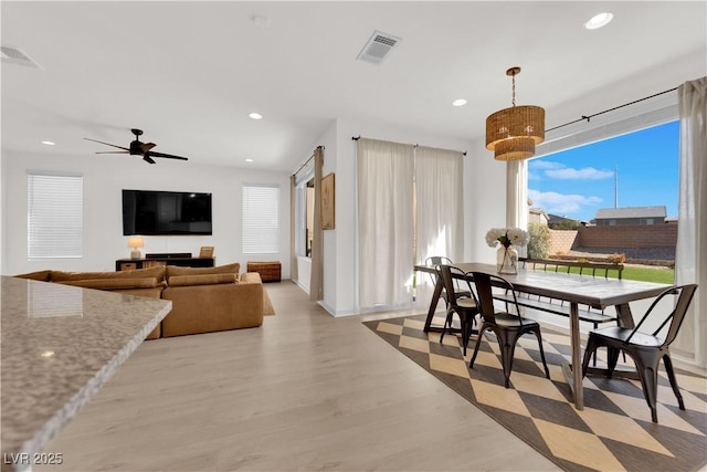 dining area featuring light hardwood / wood-style floors and ceiling fan