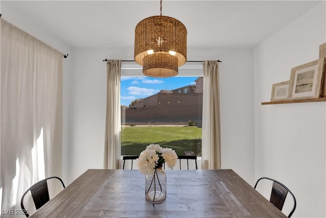 unfurnished dining area with an inviting chandelier