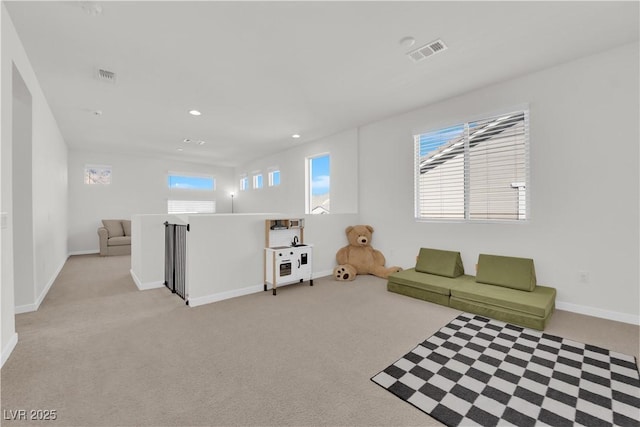 living room featuring plenty of natural light and light colored carpet