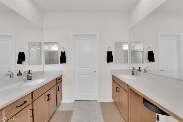 bathroom featuring tile patterned floors, a shower with door, and vanity