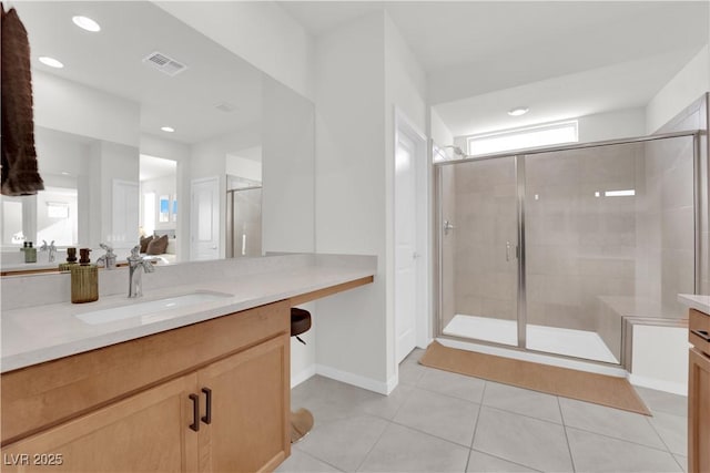 bathroom with tile patterned flooring, vanity, and a shower with shower door