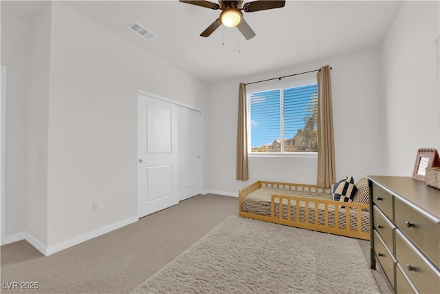 bedroom featuring ceiling fan, light colored carpet, and a closet