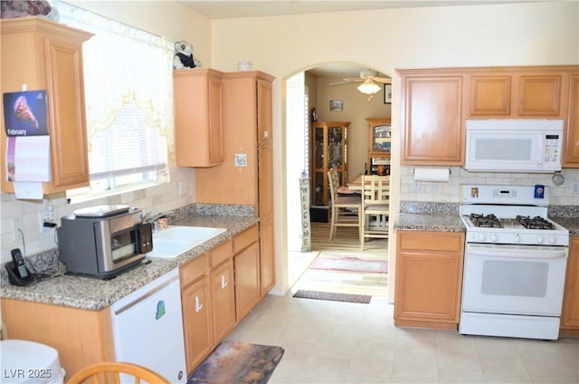 kitchen with sink, white appliances, decorative backsplash, and ceiling fan