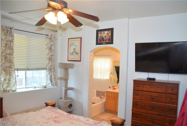 bedroom featuring ceiling fan and ensuite bath