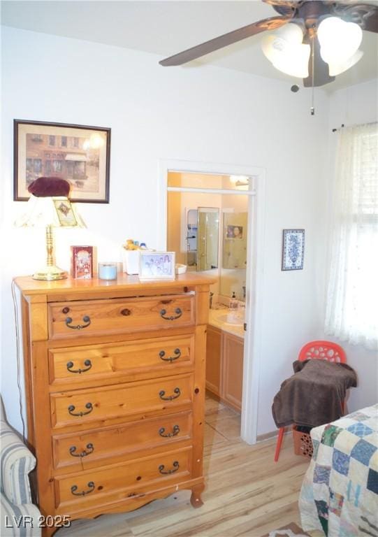 bedroom featuring ceiling fan, connected bathroom, and light hardwood / wood-style floors