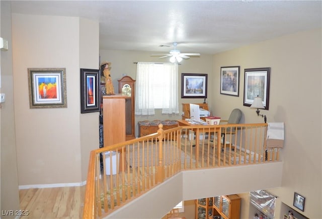 interior space with ceiling fan and wood-type flooring