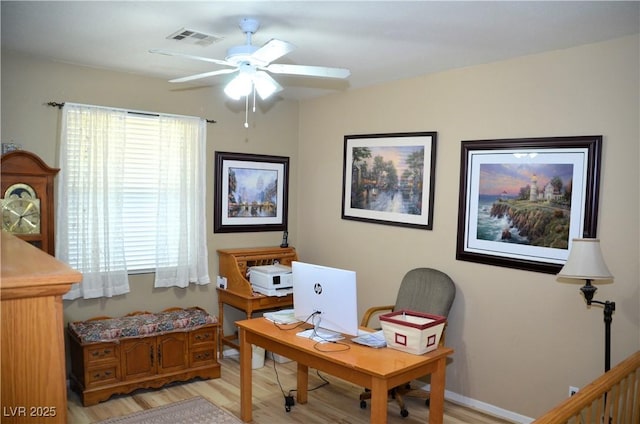 office with ceiling fan and light hardwood / wood-style flooring