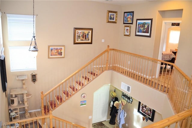 stairs featuring a high ceiling