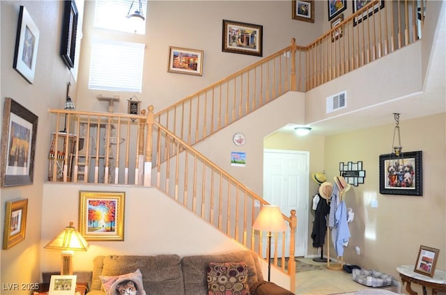 staircase with a towering ceiling