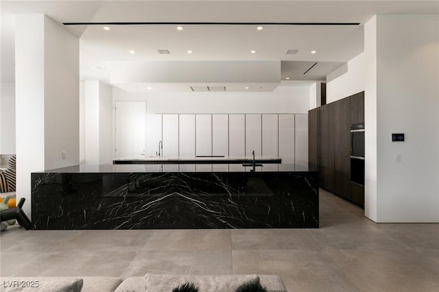 kitchen with white cabinetry and sink