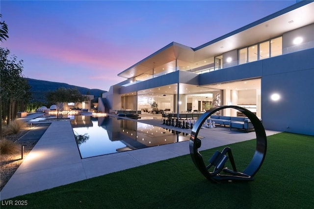 view of pool at dusk