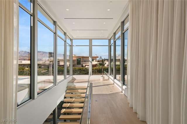 unfurnished sunroom with a mountain view