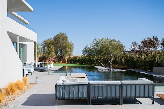 view of pool with a patio area, an outdoor hangout area, and a water view