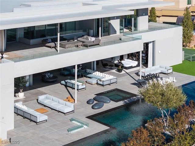 exterior space featuring an outdoor living space, a patio area, and an in ground hot tub