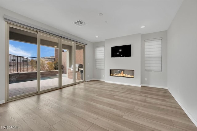 unfurnished living room with light hardwood / wood-style flooring