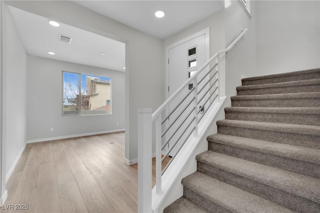 stairway featuring hardwood / wood-style floors