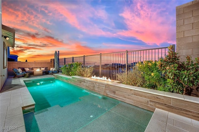 pool at dusk with an outdoor living space and pool water feature