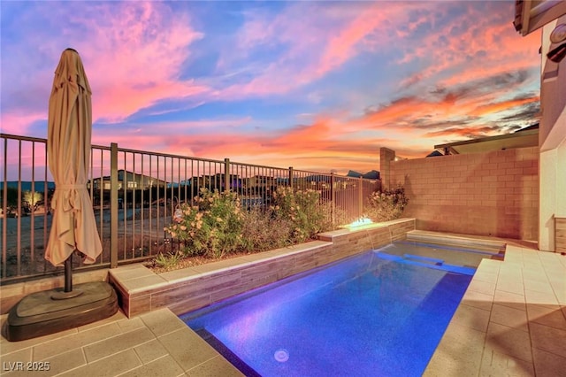 view of pool at dusk