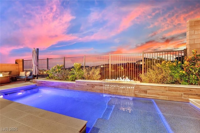 pool at dusk with pool water feature