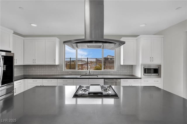 kitchen featuring white cabinetry, stainless steel appliances, and island exhaust hood