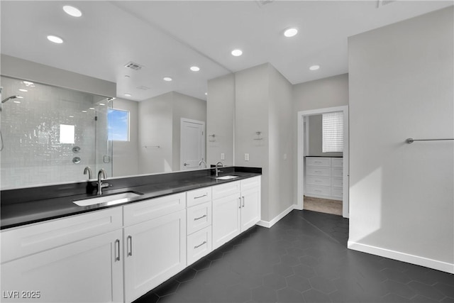 bathroom featuring walk in shower and vanity