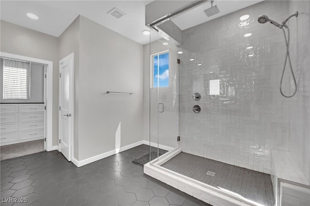 bathroom with tile patterned flooring and walk in shower