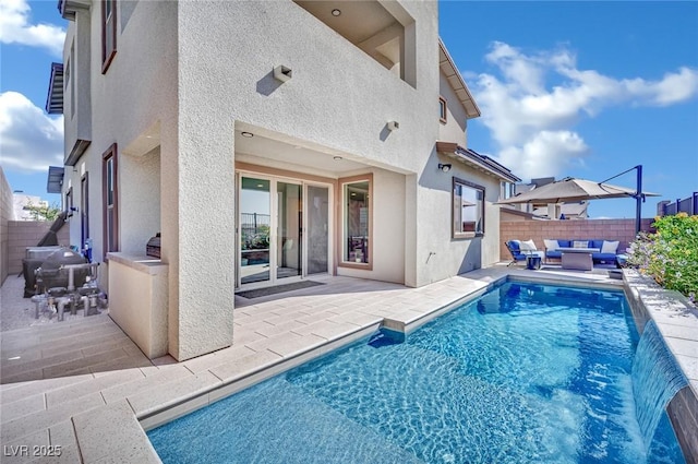 back of property with an outdoor living space, pool water feature, and a patio area