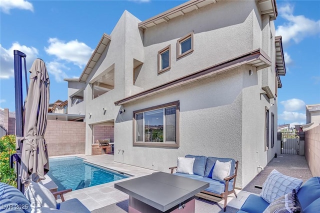 back of house with an outdoor living space, a patio area, and a fenced in pool