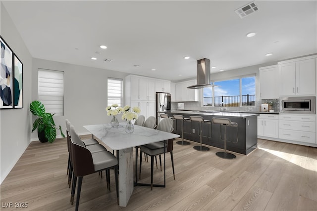 dining space with light hardwood / wood-style flooring