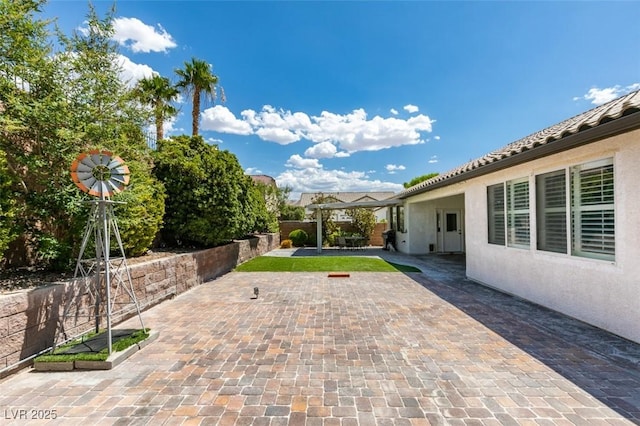 view of patio / terrace featuring fence