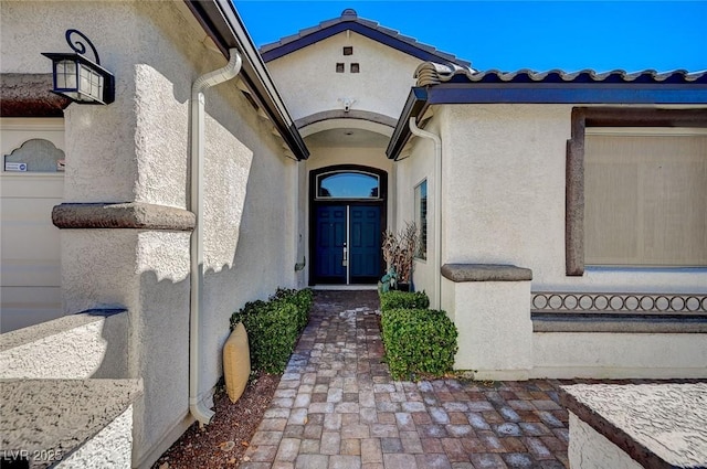 doorway to property with stucco siding