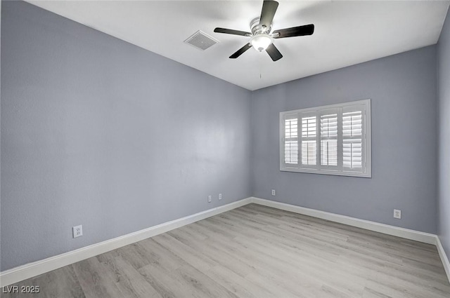 unfurnished room with visible vents, ceiling fan, baseboards, and wood finished floors