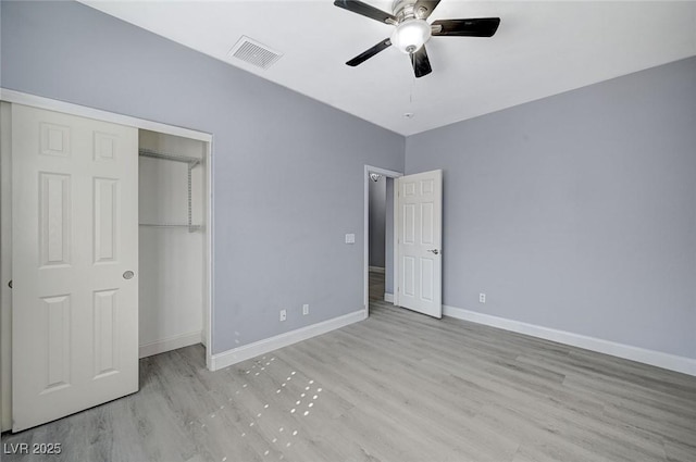 unfurnished bedroom featuring wood finished floors, visible vents, and baseboards