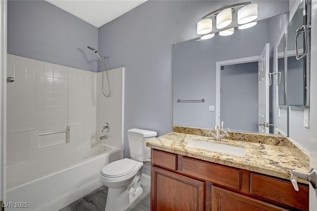 full bathroom featuring bathtub / shower combination, vanity, and toilet