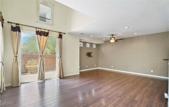 empty room featuring dark wood-type flooring and ceiling fan