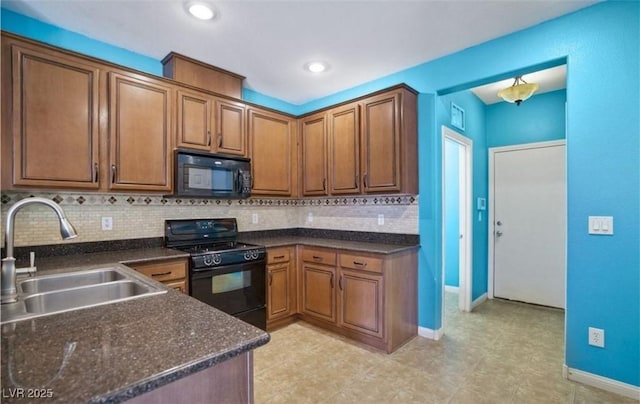 kitchen with sink, backsplash, and black appliances