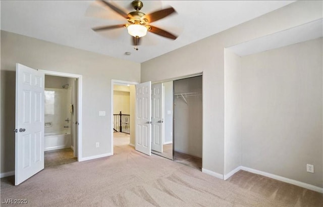 unfurnished bedroom with ensuite bathroom, light colored carpet, ceiling fan, and a closet