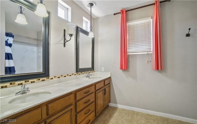 bathroom featuring vanity, decorative backsplash, and curtained shower