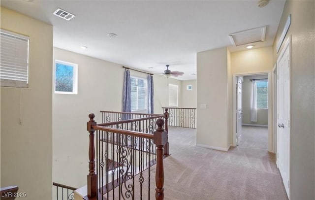 corridor featuring light colored carpet